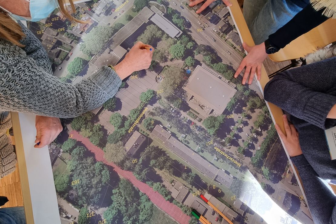 In ein Luftbild des Schulgeländes werden Planungsideen eingezeichnet.
