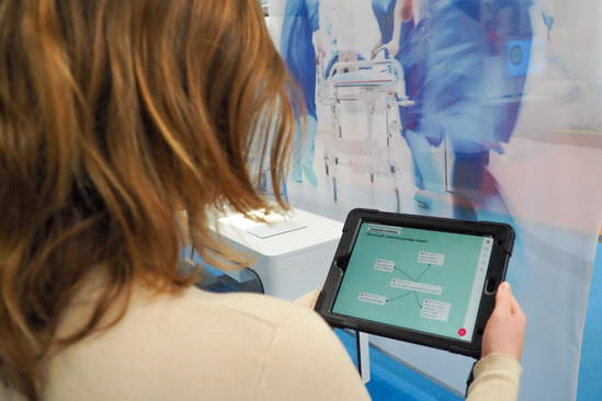 Mädchen hält ein Tablet in der DASA Arbeitswelt Ausstellung